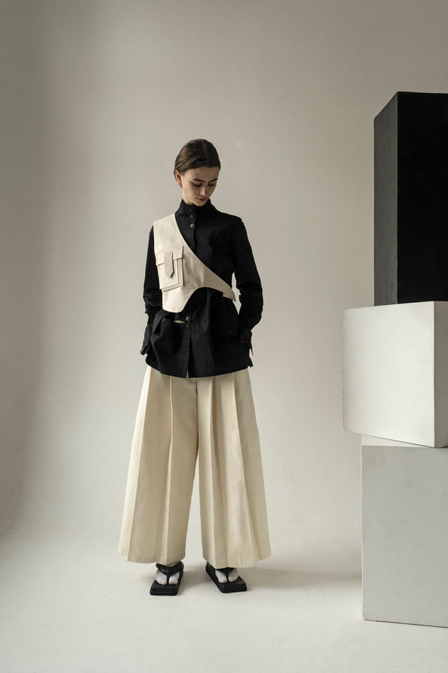 Crème geplooide broek