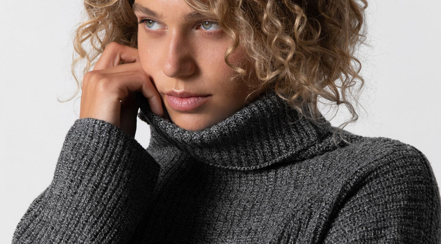 Woman wearing dark grey Rhea turtleneck sweater