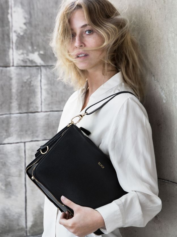 Woman holding a black shoulder bag