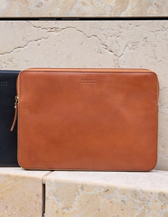 Brown leather sleeve on a stone surface