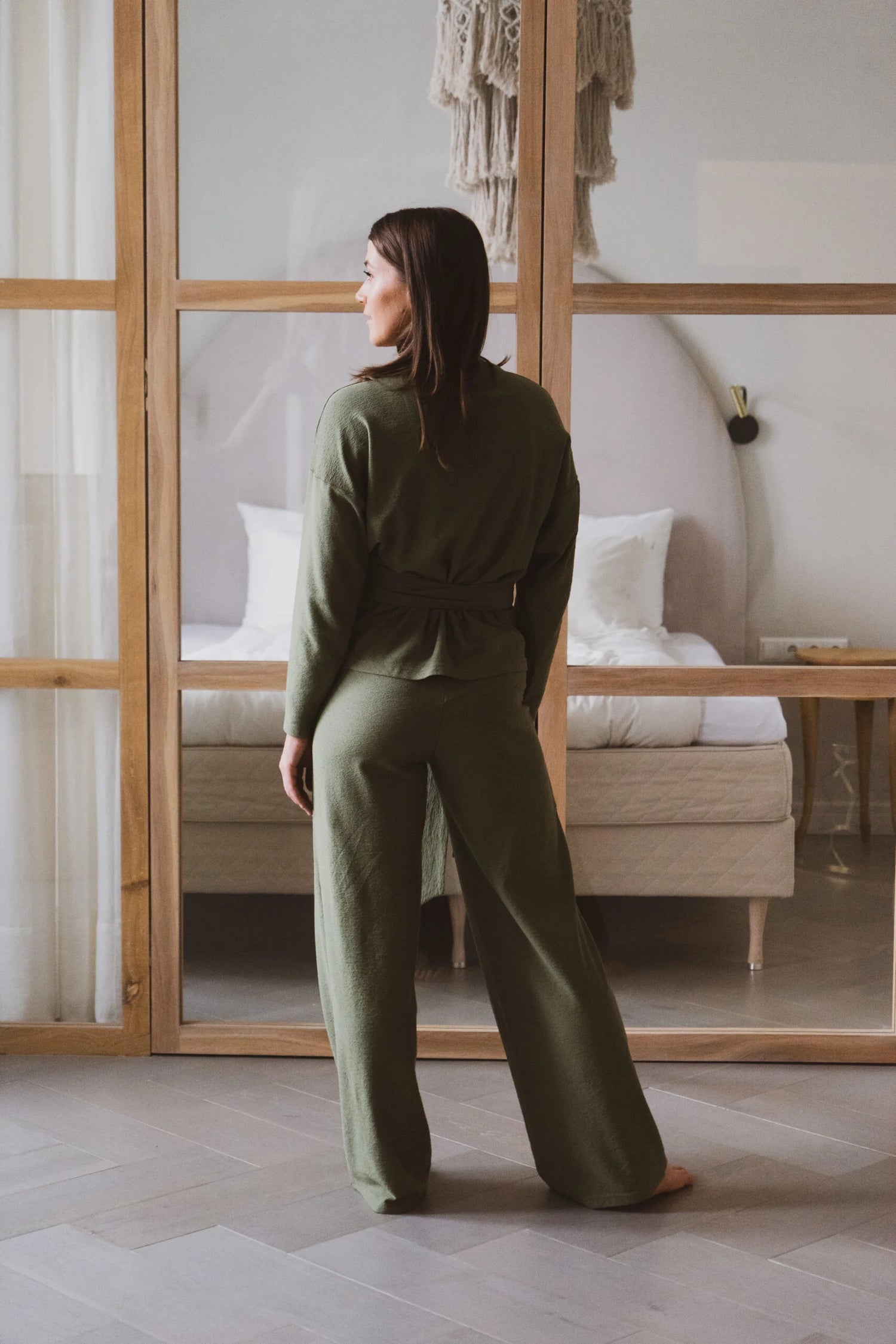 women facing the back with a green jumpsuit