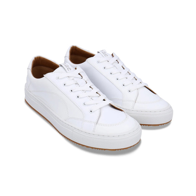 White sneakers with brown soles on a white background