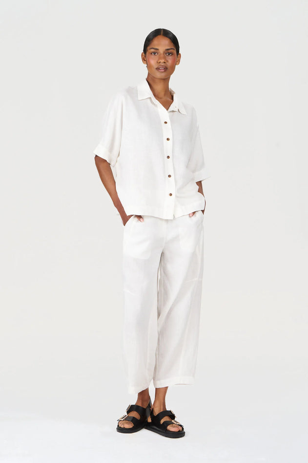Woman wearing a white shirt and pants on a white background