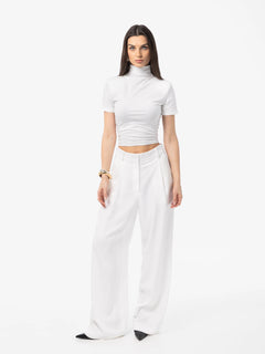 Woman wearing a white outfit on a white background