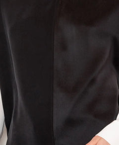 Close-up of a black garment with a visible texture