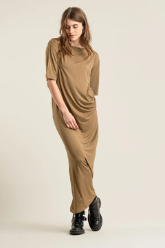 Woman wearing a brown dress on a beige background