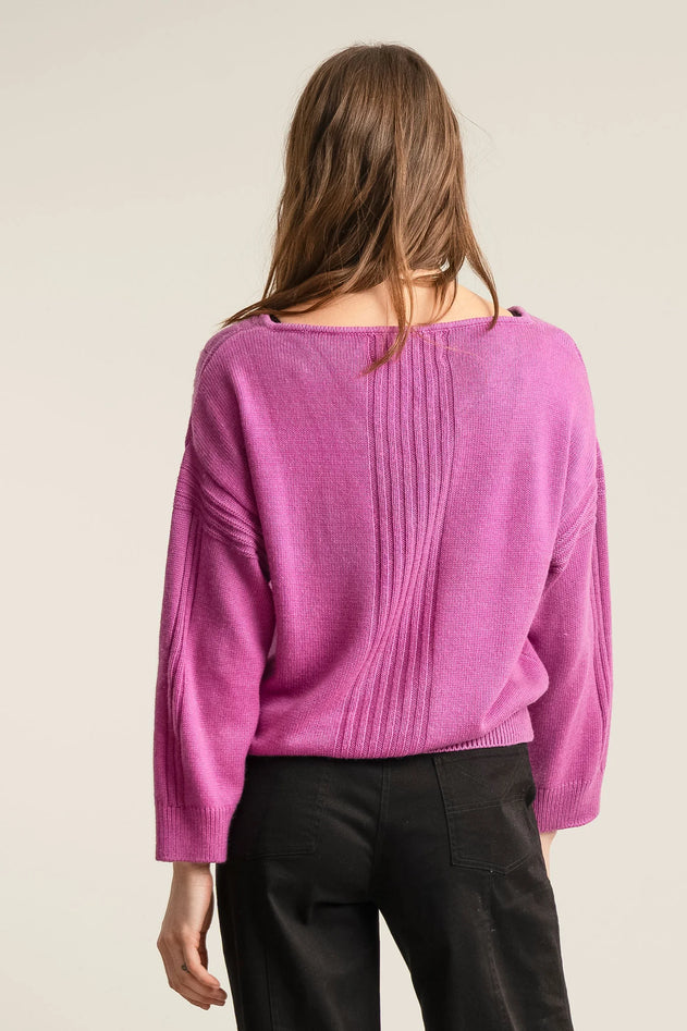 Woman wearing Komodo fuchsia pink merino wool jumper
