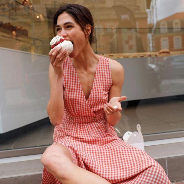 Woman eating ice cream in red-white checkered dress by INDI&COLD