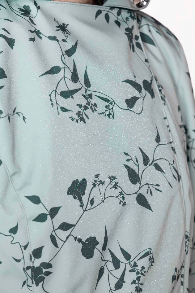 rainsisters-coat-minty-meadow-waterproof-green-floral-close-up.jpg?v=1779055013