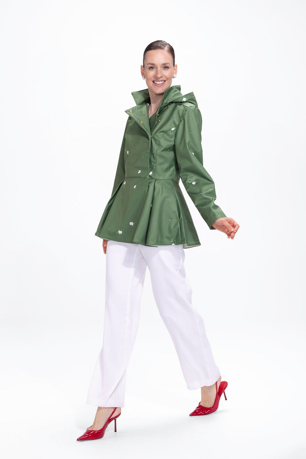 rainsisters-coat-primrose-green-waterproof-green-floral-in-motion.jpg?v=1779056014