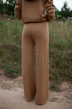 Camel wide-leg merino pants in casual lounge setting