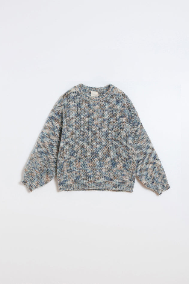 A long-sleeve knit sweater with a textured, heathered pattern in shades of blue, beige, and gray, laid flat against a clean white background.
